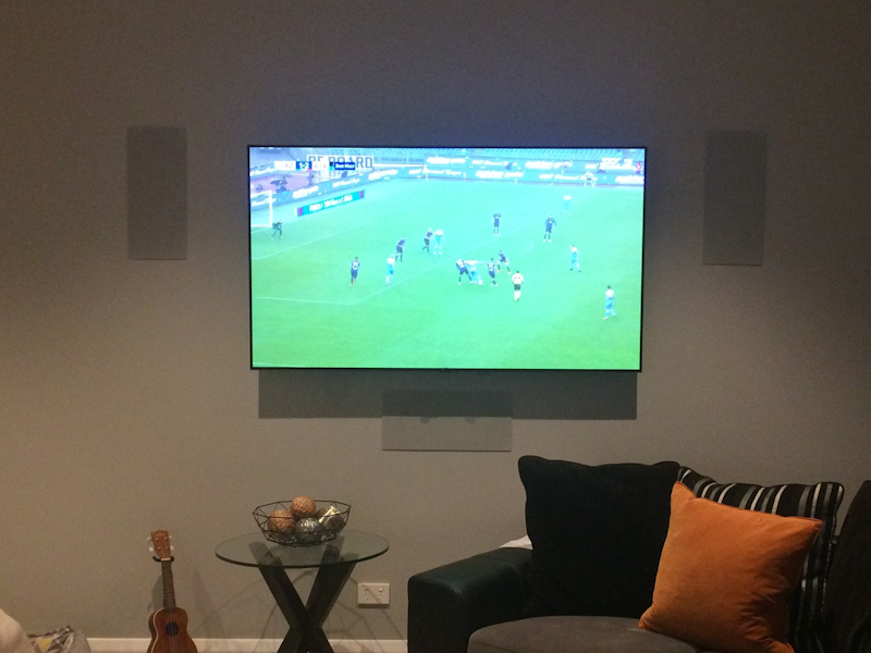 A wall-mounted TV with no visible wires